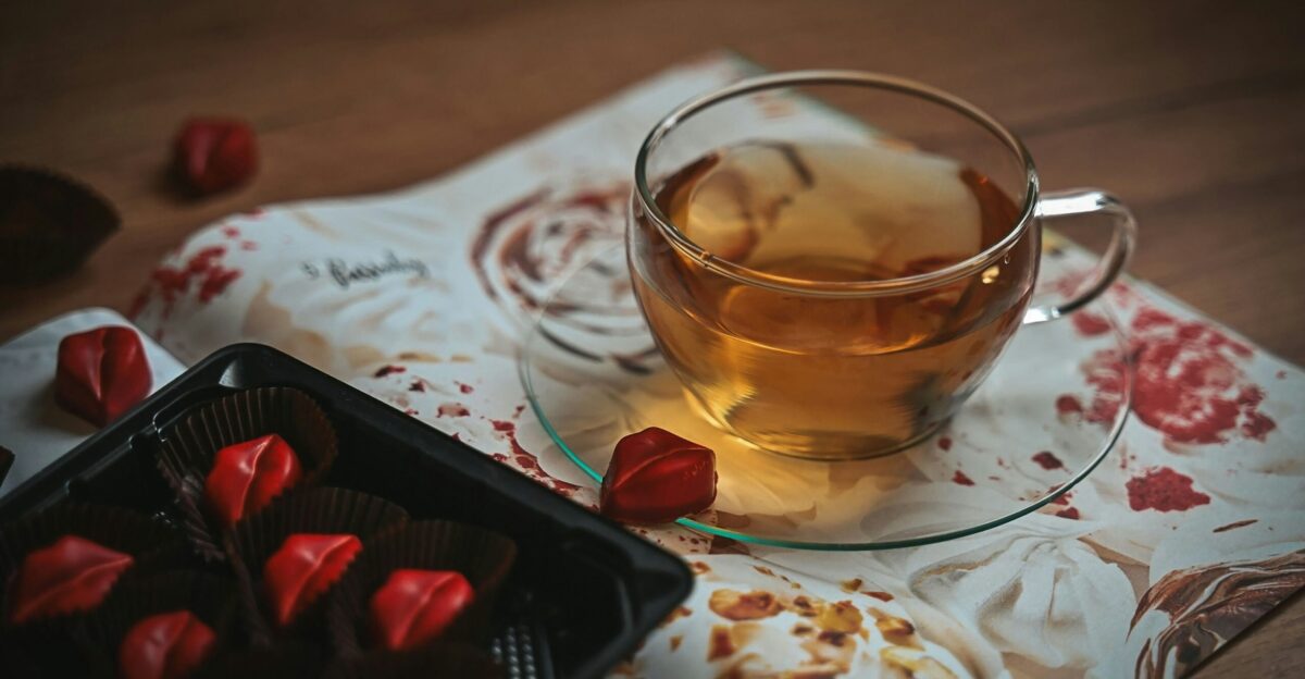 Tea and chocolates sit on a floral fabric
