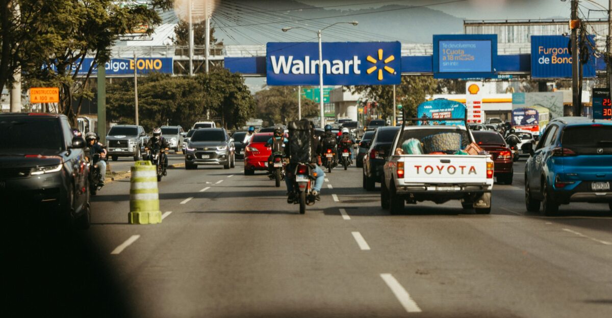 Busy road traffic passes a walmart store
