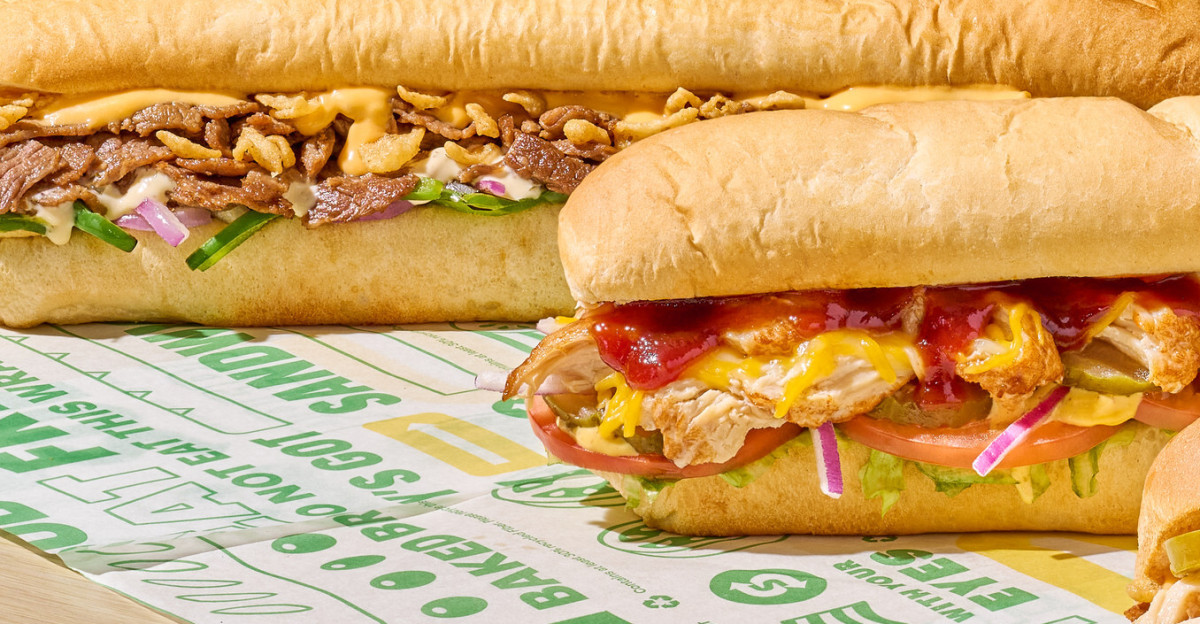 Cheesy Garlic Steak Honey Mustard BBQ Chicken and Spicy Nacho Chicken footlong subs taken in a Subway restaurant in 2023