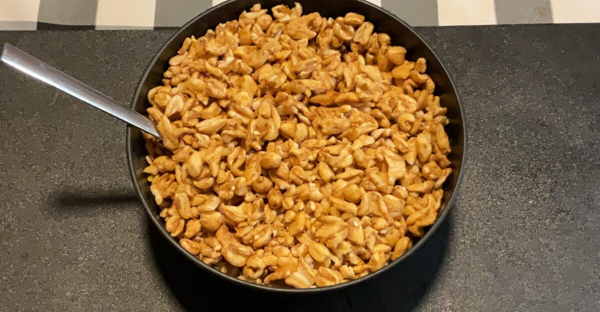Golden Crisp breakfast cereal in a plastic black bowl with a spoon